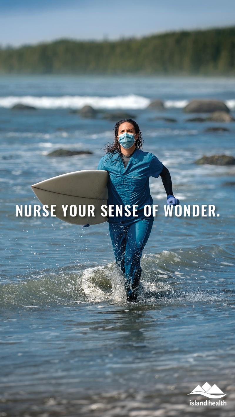 Nurse Your Sense of Wonder, a nurse in a mask and scrubs running into the ocean with a surfboard